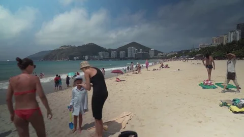 Crowded beach of Dadonghai on the tourist island of Hainan on a hot spring day Stock Footage
