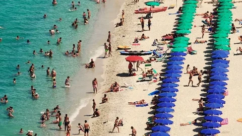 Crowded beach in Italy during a summer day: crystal clear emerald water Stock Footage 84119357