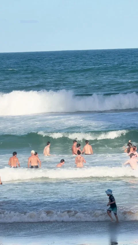 Crowded Beach with People Wading in Ocean Waves at Surfers Paradise Stock Footage 326272866