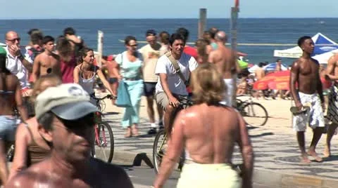 Crowded Beach In Rio De Janeiro, Brazil, Focus On Bicycle Rider 動画素材 19705527