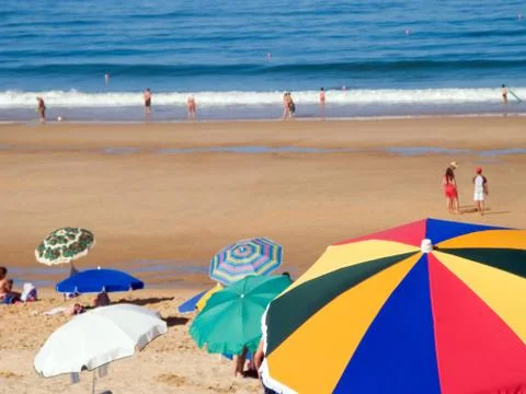 Crowded beach at summer with sun umbrellas. Stock Photos