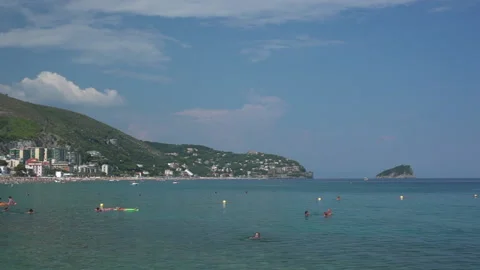 Crowded beach surrounded by green hills in Liguria in Italy - Pan, Handheld Video stock 167699411