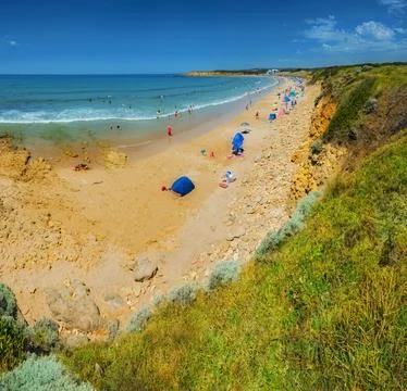 Crowded beach under bright summer sun, Torquay, Great Ocean Road, Australia Stock Photos