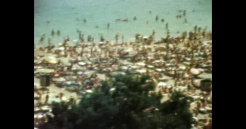 Crowded beach in USSR, people sunbathing and swimming at Soviet resort, 1970s. Stock-Footage 332547086