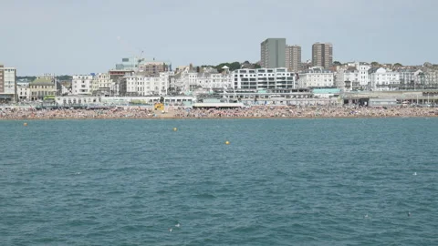 A crowded beachfront with buildings viewed from the water. Stock Footage 337676320