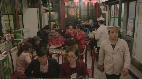 Crowded Beijing Restaurant Interior with Diners and Staff Serving Food Stock Footage 345772600