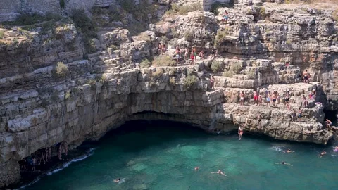 Crowded Cliff Jumping Spot above Clear Sea Pool in Italy Stock Footage 345622641