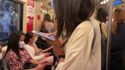 Crowded commuters riding on MRT subway train rush hour. Urban commute, Bangkok Stock Footage 230512191