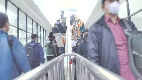 Crowded commuters using escalators at the railway station in the morning Stock Footage 277399043