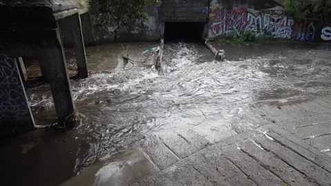 Crowded drainage during a storm rain, slow motion. Stock Footage 148807985