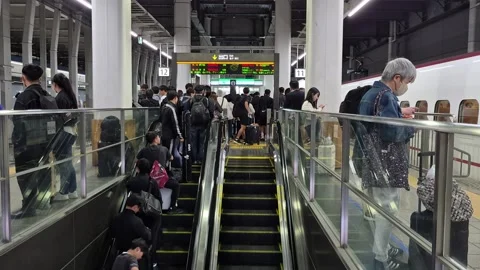 Crowded escalator and platform at Hakata Station Video stock 337282217