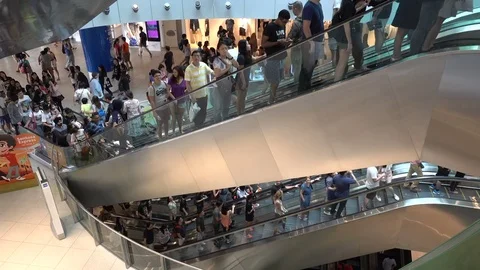 Crowded escalators in modern shopping mall during weekend in Singapore Stock Footage 78460504