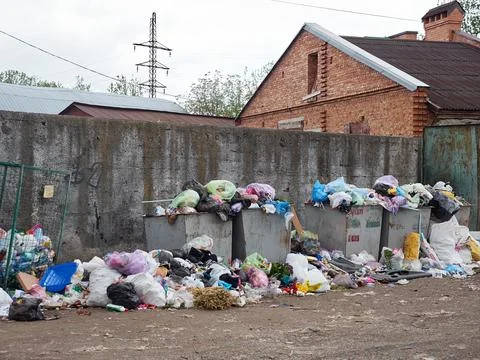 Crowded garbage cans. The problem of recycling and utilization of garbage. Ukrai Stock Photos