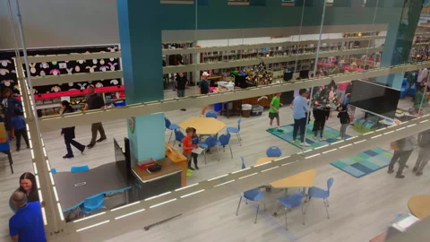 The crowded hall of an American elementary school. Library hall, book fair Stock Footage 315522176