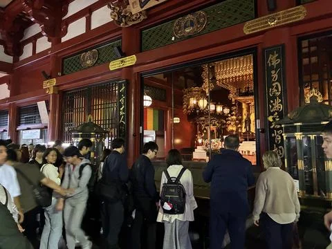 A crowded interior scene at the main hall of Senso-ji Temple Stock Photos