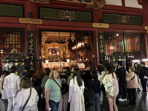 A crowded interior scene at the main hall of Senso-ji Temple Stock Photos