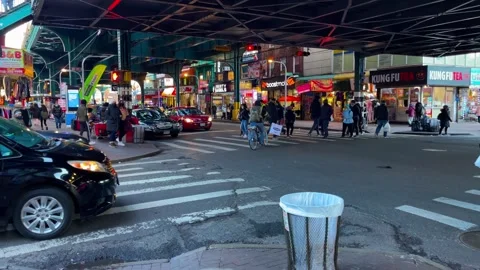 Crowded intersection below elevated subway in Queens Stock Footage 335203285
