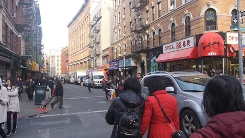 Crowded Intersection With People Walking Near Buildings - Pan - Right To Left 스톡 동영상 86835266