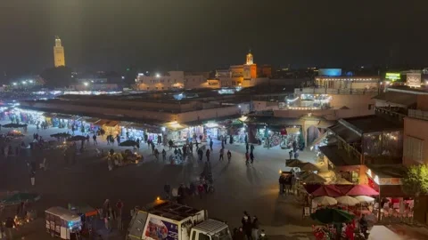 Crowded Jemaa el Fna square at night from restaurant rooftop Stock Footage 324686599