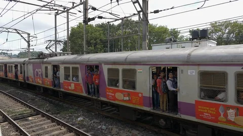 Crowded local train running and people hanging out in doors. Stock Footage 124950158