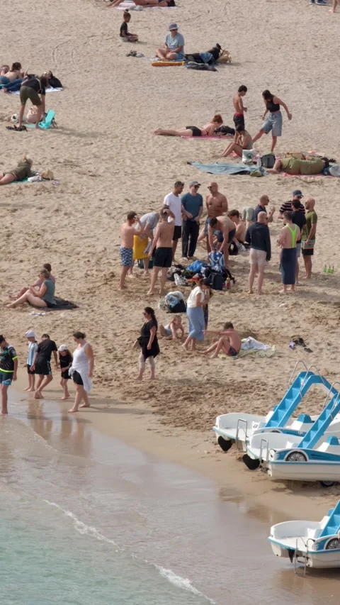 Crowded Mediterranean Beach with Tourists Sunbathing and Pedal Boats in Cassis Stock Footage 340305441