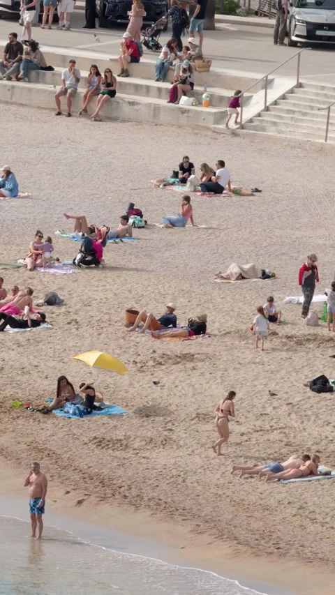 Crowded Mediterranean Beach with Tourists Sunbathing and Swimming Stock Footage 340881435