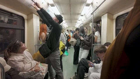 Crowded Metro Carriage Interior With Standing and Seated Passengers Stock Footage 340355183