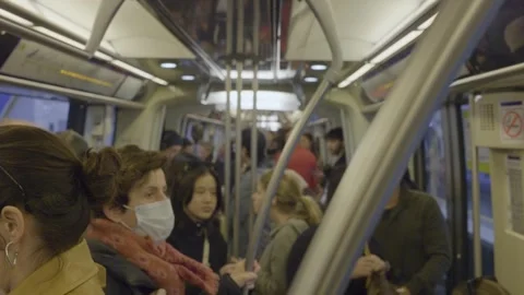 Crowded metro train ride in Paris showing diverse passengers standing and Stock Footage 306387935