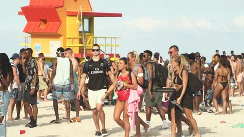 Crowded Miami Beach at spring break time. Beach full of people in a sunny day Stock Footage 90790881