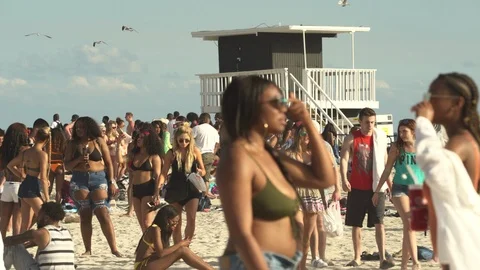 Crowded Miami Beach at spring break time. Beach full of people in a sunny day Stock Footage 90790952