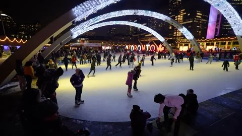 Crowded night ice skating at Nathan Phillips Square Toronto Stock Footage 330859497
