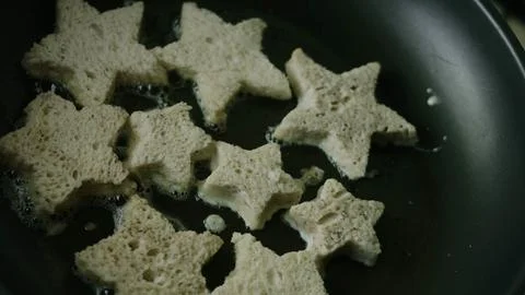 Crowded pan of bread stars developing golden edges Stock Photos