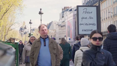 Crowded Paris Sidewalk Flows past Minimalist Billboard with Handwritten Stock Footage 333381901