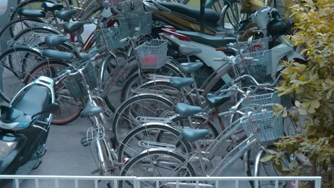 A crowded parking area filled with multiple commuter-style step-through bicycles Stock Footage 340624675