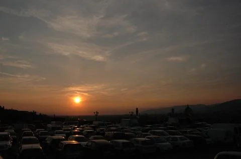 Crowded Parking Lot Beneath Dramatic Urban Sunset Stock Photos