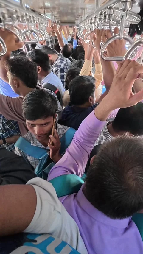 Crowded passenger train car filled with people holding handles Stock Footage 339339895
