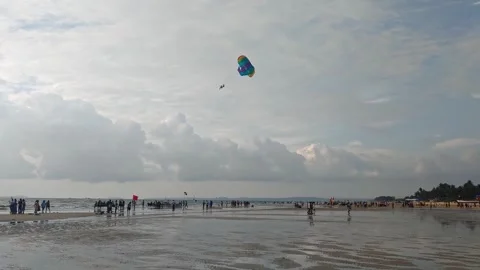Crowded People with parasailing and cloud sky at colva beach, goa, india. day Stock Footage 321882419