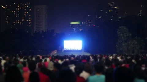 Crowded people watching tv outside in city Stock Footage