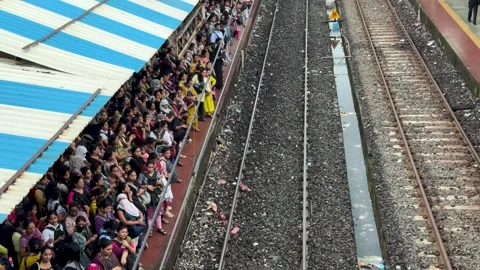 Crowded platform with commuters waiting for a local train in Mumbai, India Stock Footage 341455729