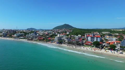 Crowded Praia dos Ingleses beach Florianopolis Brazil summer season slow drone 스톡 동영상 332134293