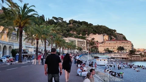 Crowded Promenade des Anglais in Nice towards Castle Hill Stock Footage 336922955