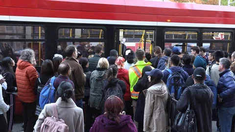 Crowded public transit buses full of people in Toronto at rush hour Stock Footage 125780103
