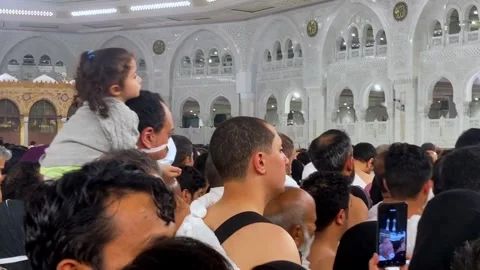 A crowded scene at the Grand Mosque in Mecca, Saudi Arabia, featuring pilgrims Stock Footage 345835772