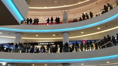 Crowded Shopping Mall Interior with Multilevel Walkways and Eager Shoppers Stock Footage 311852363