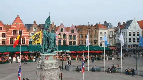 Crowded square with statue and flags in bruges, belgium Video stock 88692191