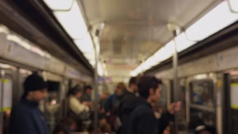 A crowded subway interior filled with passengers who are engaged in their daily Stock Footage 318555029