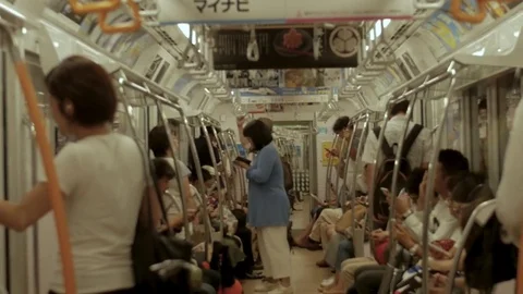 Crowded subway train at rush hour. Tokyo subway is the preferred way move Stock Footage 80427238