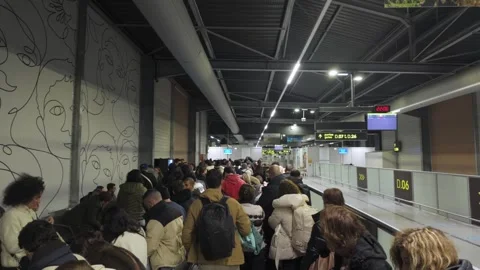 Crowded terminal queue inside a busy modern transit hall Stock Footage 322218471