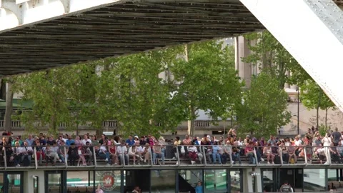 Crowded Tourist Riverboat Passing Under the Debilly Footbridge in Paris Stock Footage 335851103