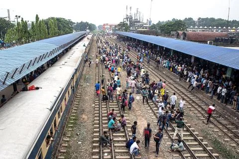 Crowded Train Station Platform with Commuters Under a Blue Canopy Stock Photos